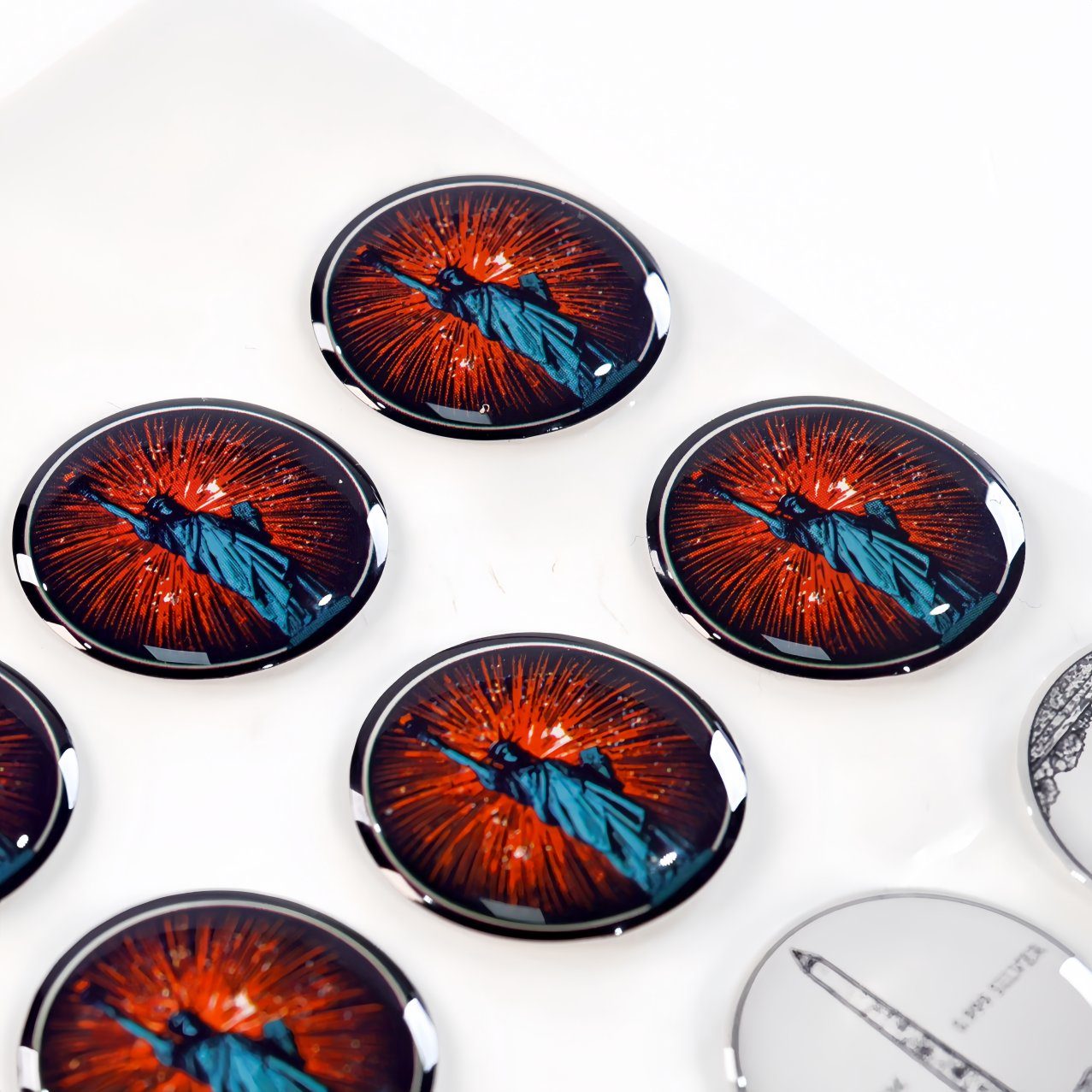 Hard dome circular stickers featuring Statue of Liberty design with red burst background