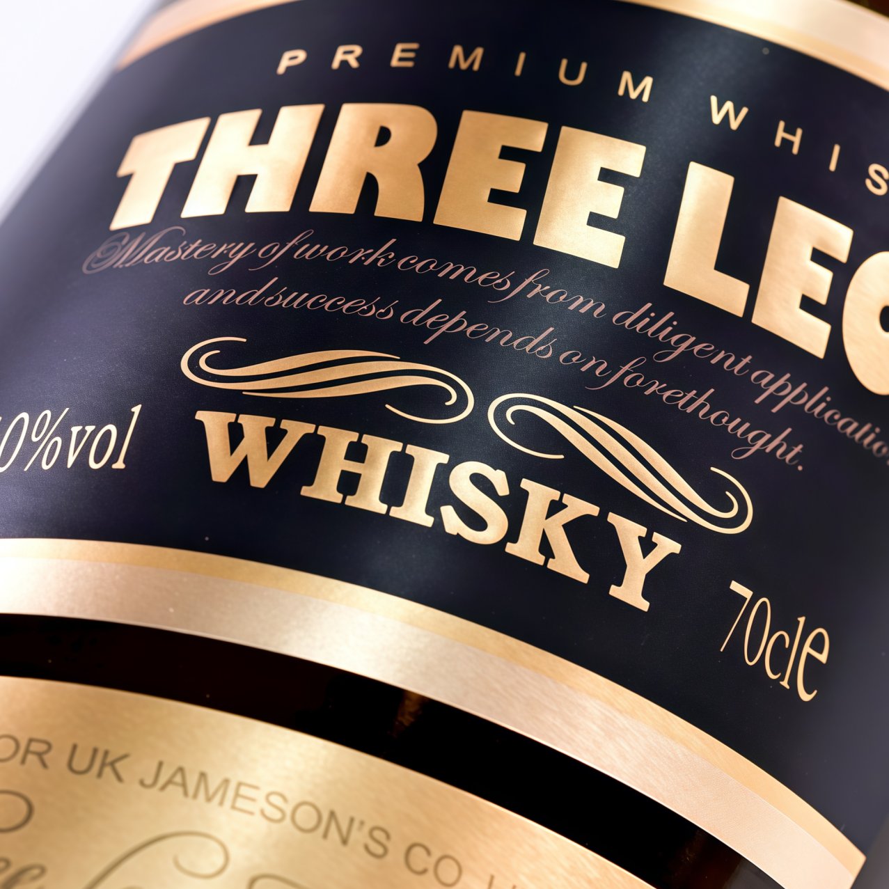 Hot foil stamped whisky label close-up showing fine gold lettering