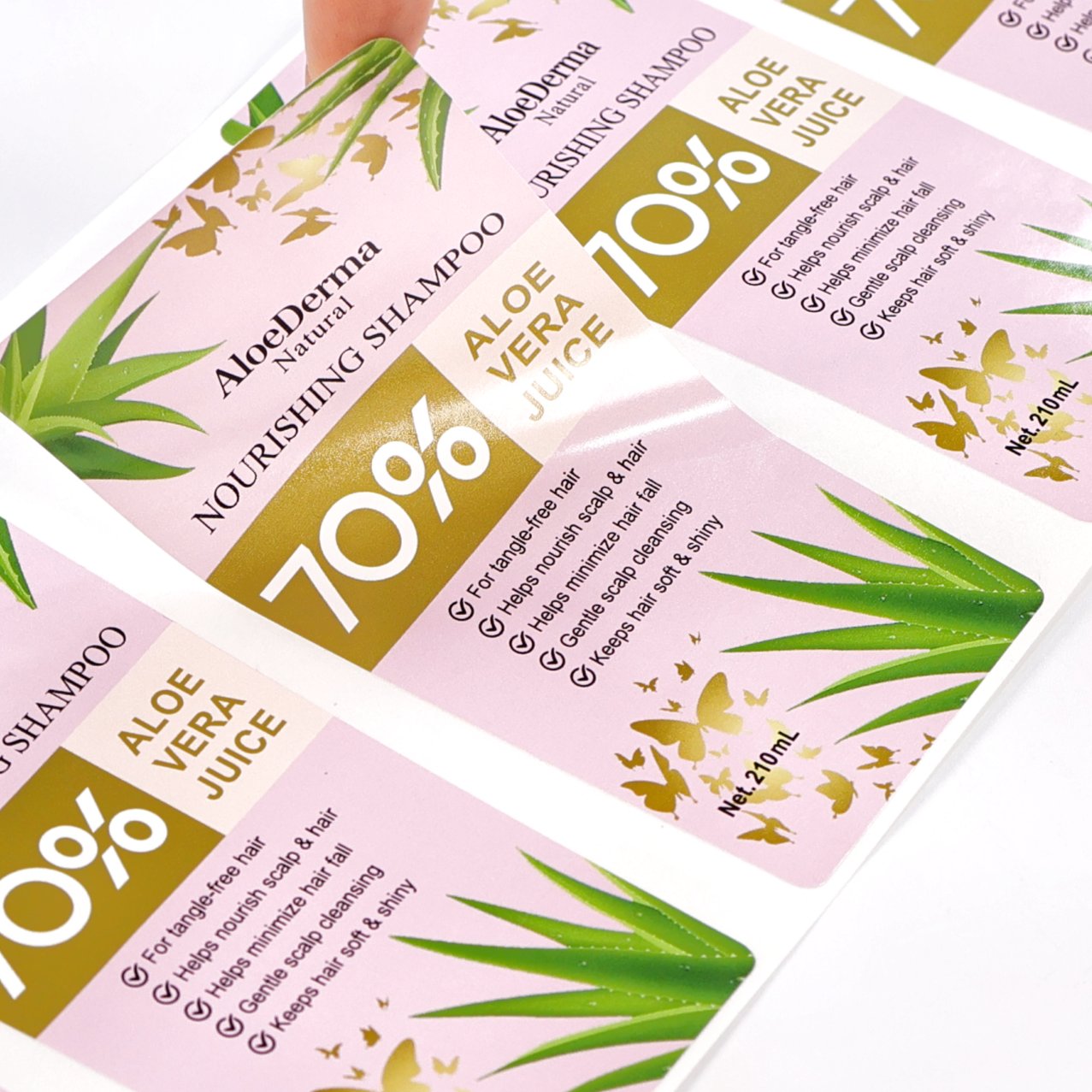 White PP synthetic labels on shampoo bottles with gold foil accents
