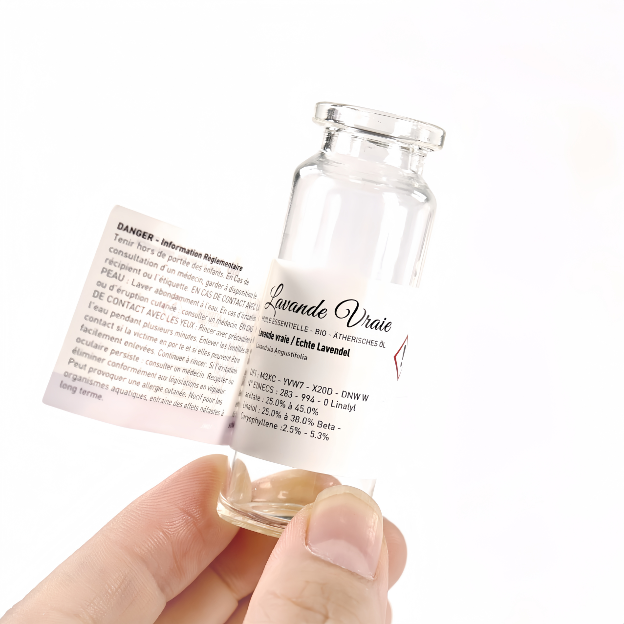Peel-open multi-layer booklet label on a small glass vial