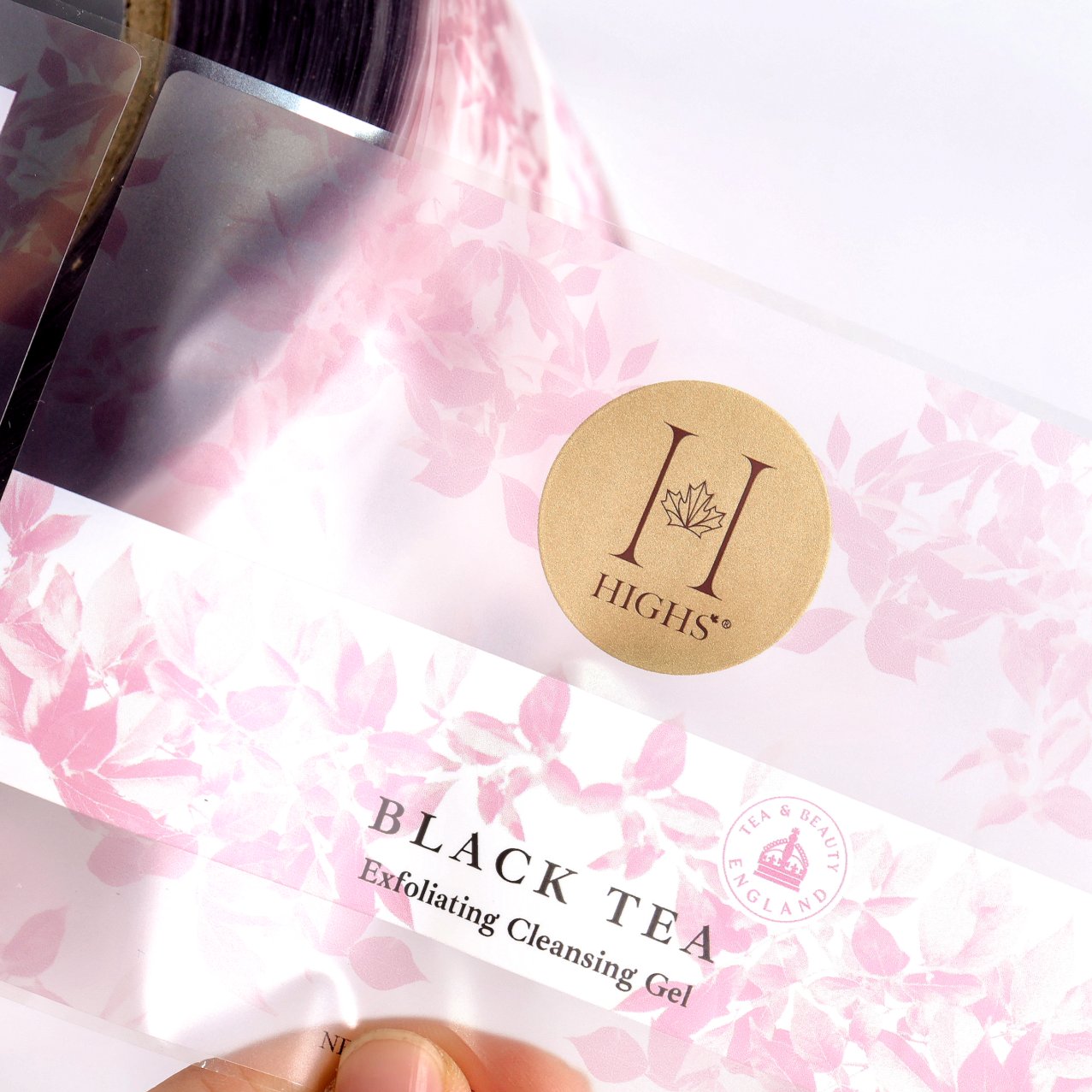 Close-up of gold foil logo on clear PET label