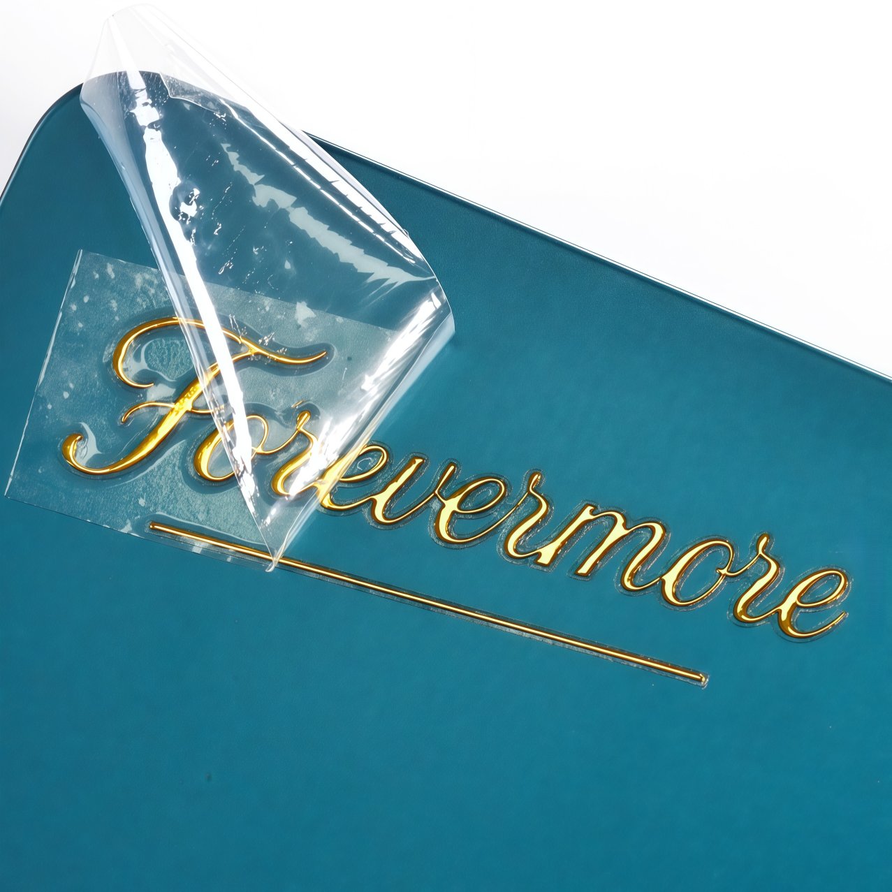 Gold foil transfer being peeled off backing sheet