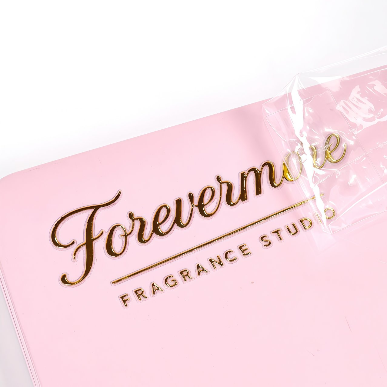 Gold foil transfer label applied to pink premium packaging