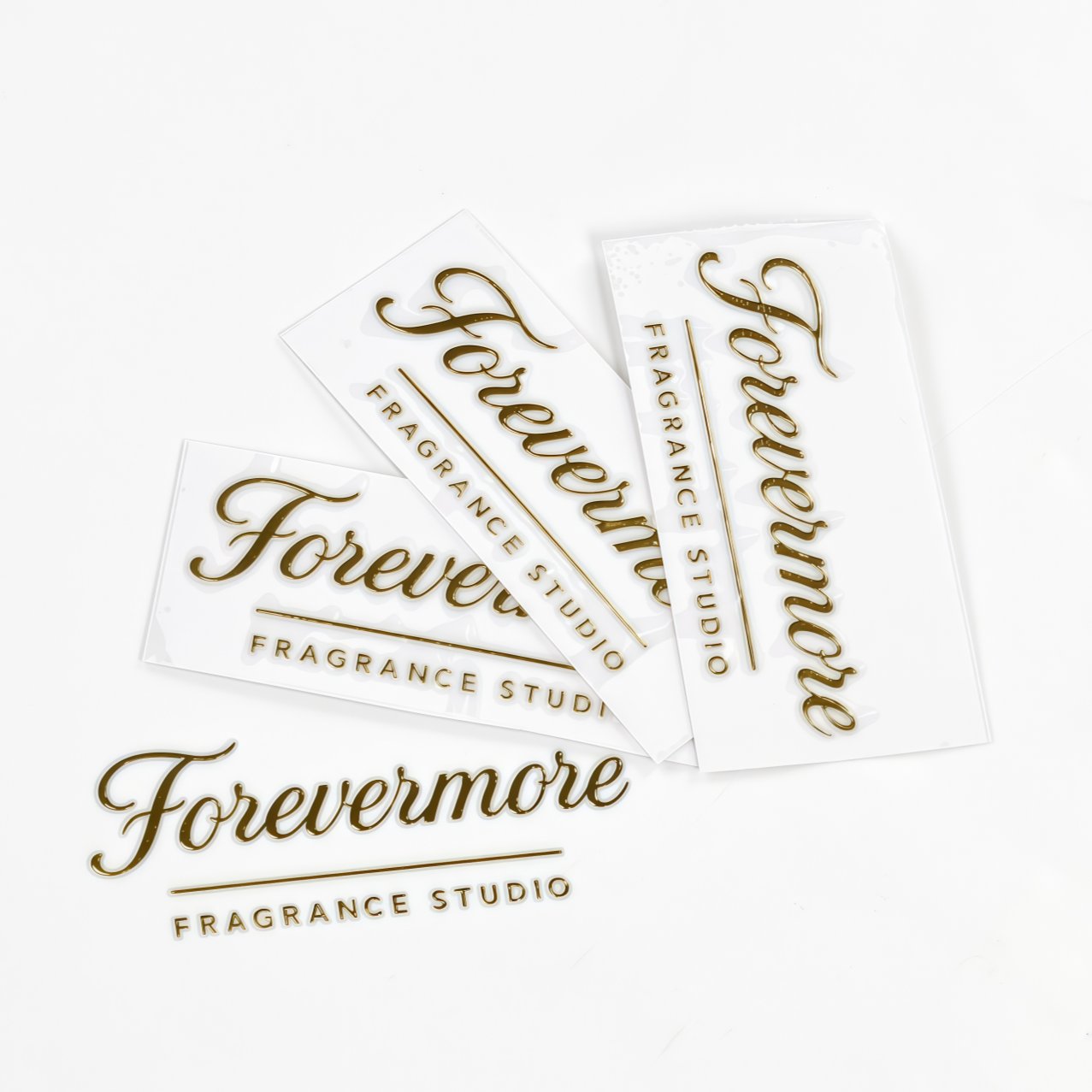 Multiple gold foil transfer labels arranged on white background