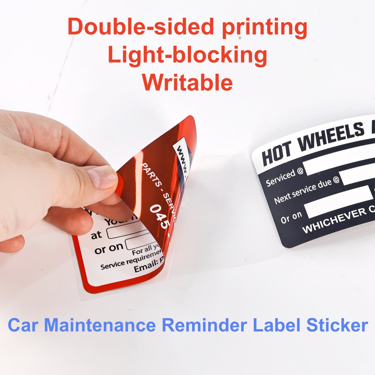 Car maintenance reminder sticker peeled open, revealing the opaque interlayer in the middle