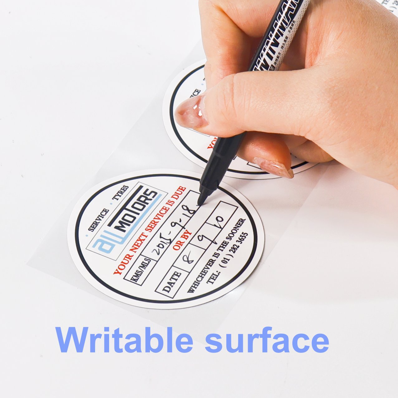 Round maintenance reminder sticker with a writable surface, filled in by pen